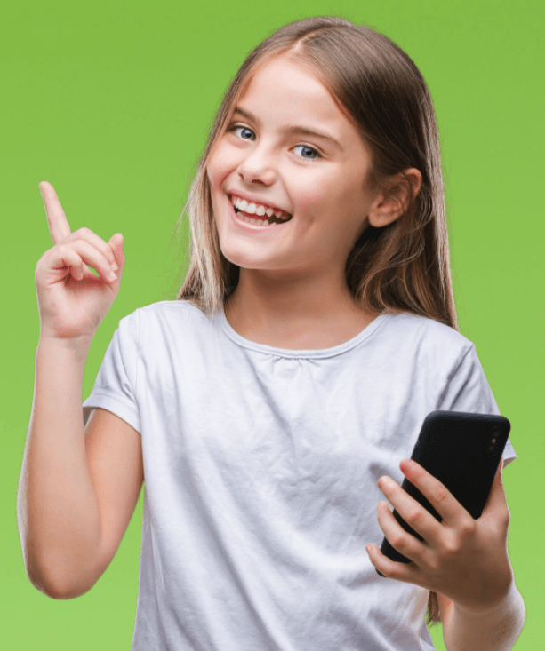 image of a girl smiling, pointing up with the right hand and holding a cell phone on the left hand