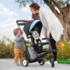 woman with a boy holding a stroller trike