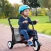boy with a helmet driving a stroller trike