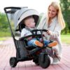 woman smiling to a boy sitting on a trike