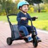 boy with a helmet driving a stroller trike