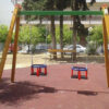 tooddler's swing with metallic horizontal bar and two safety seats top in a park