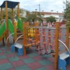 outdoor play center a slide and climbers in a park