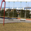 tooddler's metal swing with two seats in a park