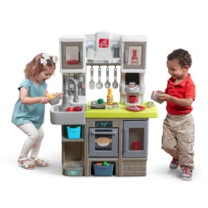 boy and girl stand aside a chef kitchen playset