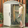 woman taking a tool from a garden storage shed