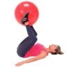 woman does an exercise with a red physiotherapy ball