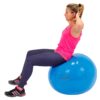 woman does an exercise with a blue physiotherapy ball