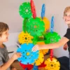 two boys play with educational wheels construction