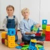 a boy and a girl playing with waffle blocks