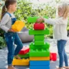 two girls playing with colorful giant building blocks