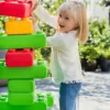 girl playing with coloful giant building blocks