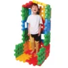 boy standing in a construction with colorful giant waffle blocks