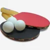 two table tennis bats and two white balls side view