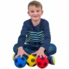 a boy sitting on the floor touching in front of him three
