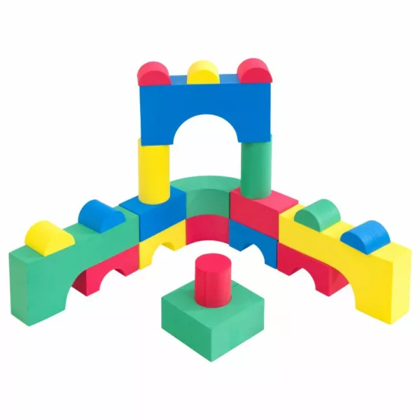 Colorful foam building blocks arranged in an arch and tower structure, featuring various shapes like arches, cylinders, and rectangles in red, yellow, blue, and green.