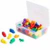 A transparent plastic box filled with colorful transportation counters in various shapes such as cars, trains, boats, airplanes, and buses, with a few pieces placed outside the box.