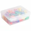 A transparent plastic box filled with colorful transportation counters in various shapes, such as cars, trains, boats, airplanes, and buses.