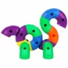 An assembled duck-like creation with colorful curved plastic building blocks in red, blue, yellow, green, orange and purple