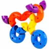 An assembled motorcycle creation with colorful curved plastic building blocks in red, blue, green, yellow, purple, and orange