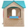 Plastic children’s playhouse with a blue arched door, red window shutters, and a blue roof, designed for indoor or outdoor pretend play (side view)