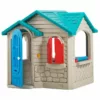 Plastic children’s playhouse with an open blue arched door, red window shutters, and a blue roof, designed for indoor or outdoor pretend play