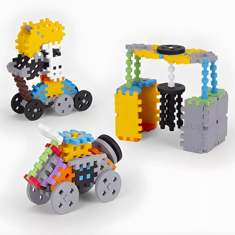 An image showing three different models built with colorful Plus-Plus Go! building blocks, including a figure on wheels, a small car, and a gantry structure with moving parts.